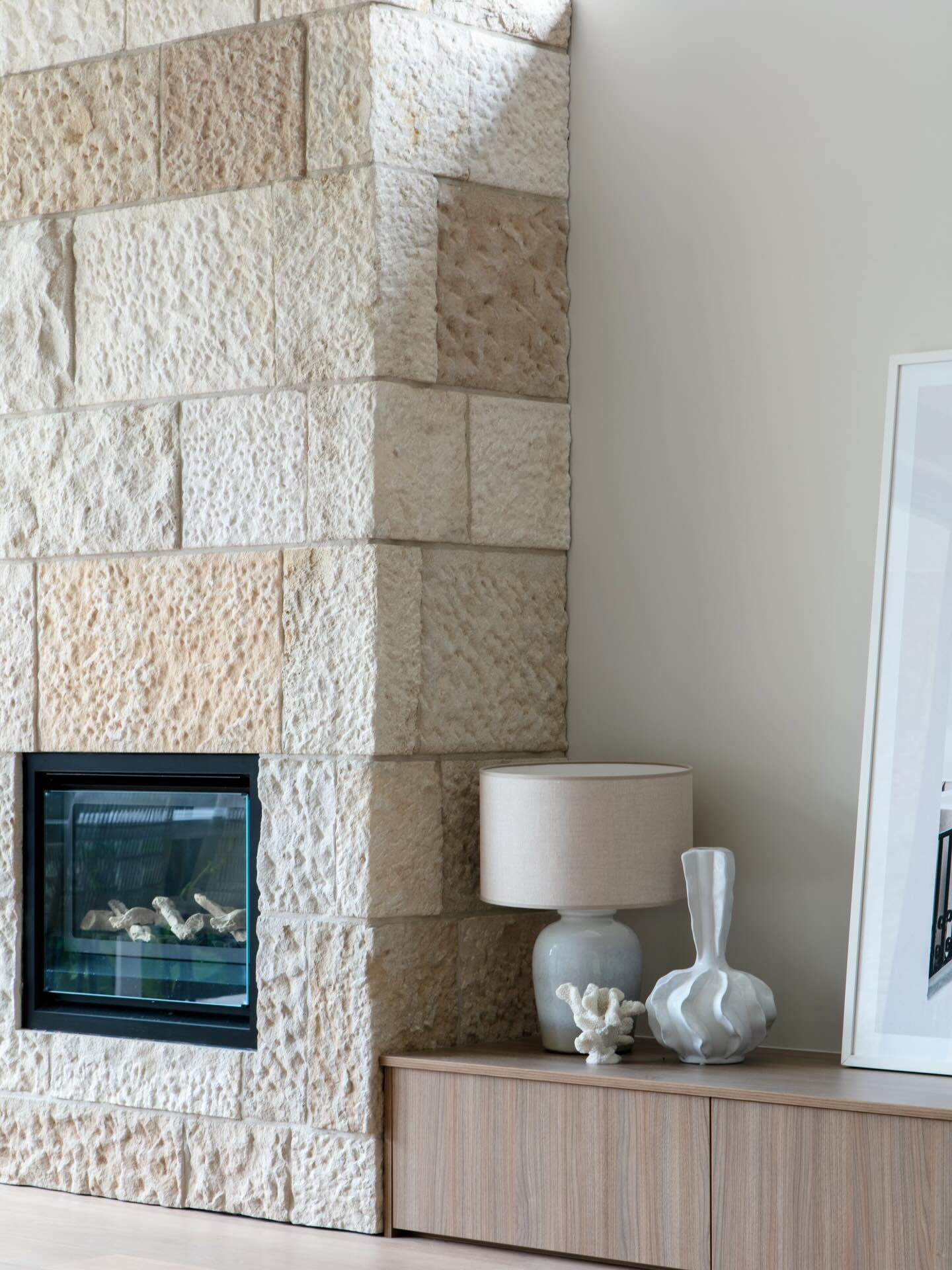 One of the many cosy corners at Project Caronia 🔥 We used the same stone on the fireplace that was installed externally on the home, to create a seamless indoor outdoor flow