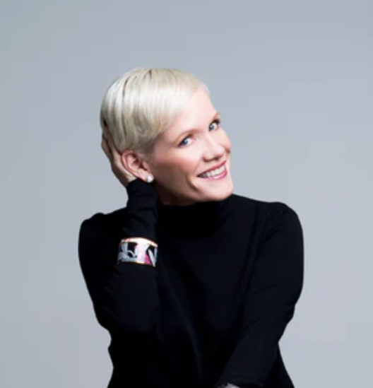 Lindsay Nicholas looking at the camera with her hand in her hair