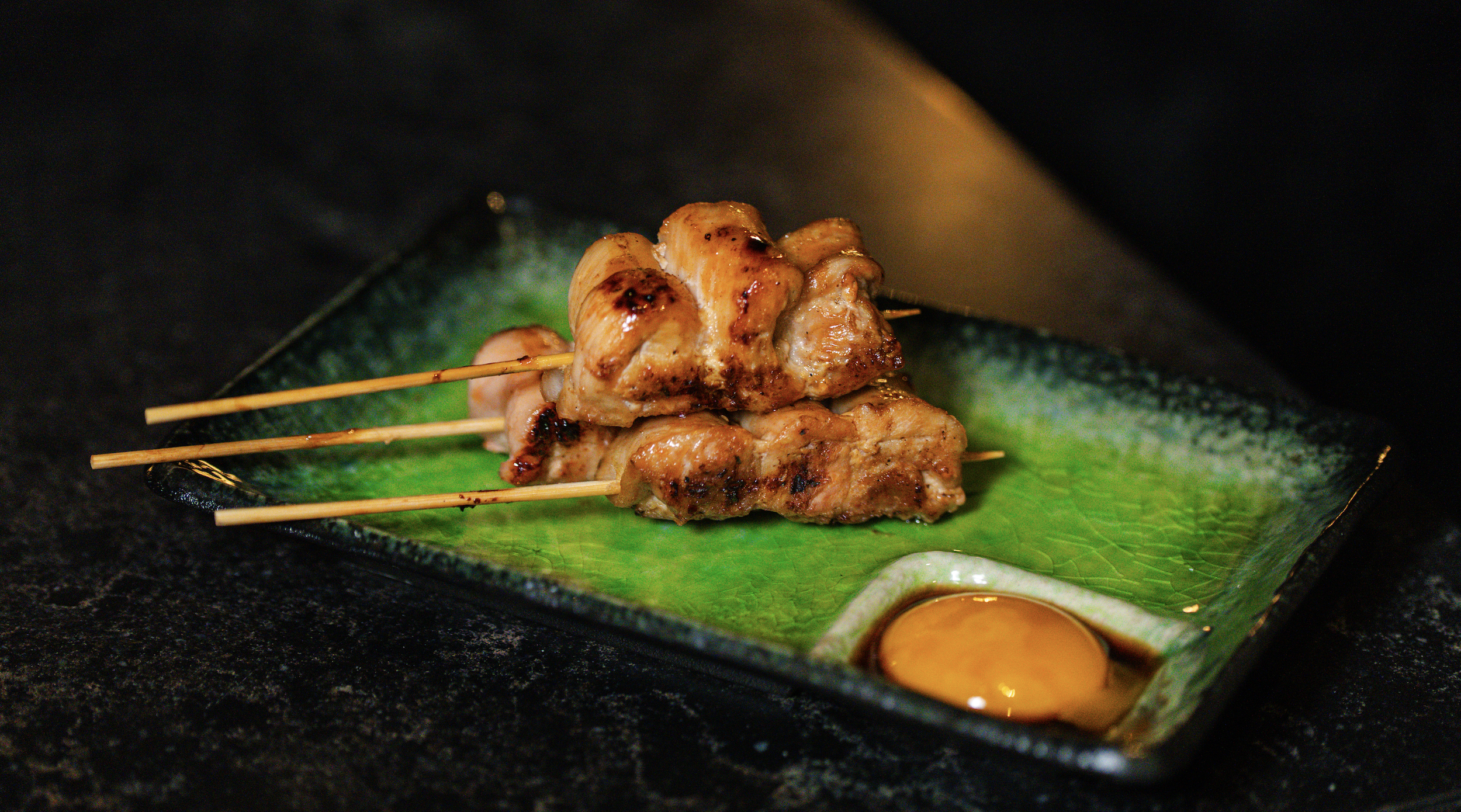 Authentic Japanese yakitori skewers served with a traditional egg yolk dip, part of the elevated shared plates menu at Zōtō in UTC Sarasota.