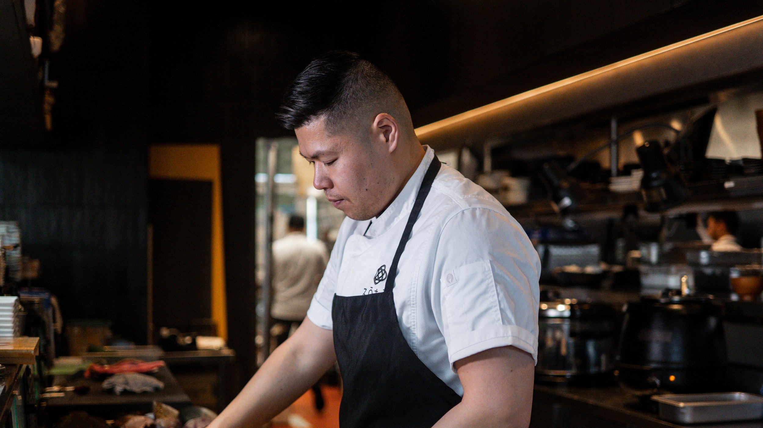 Portrait of Executive Chef Henry in his white Zoto chef coat.