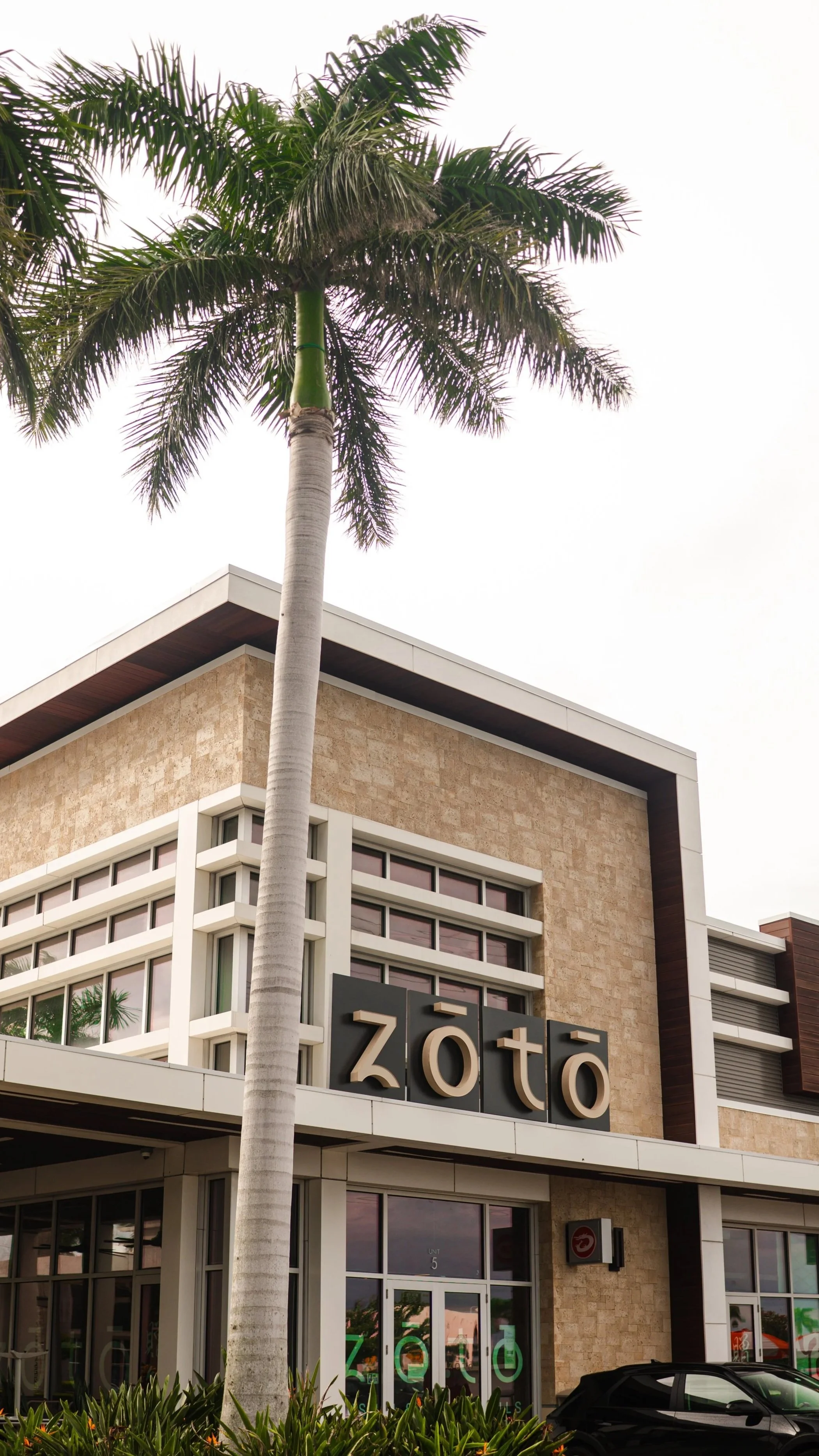 The exterior storefront of Zōtō, an elevated Japanese izakaya and premium sushi restaurant located in the West District at UTC in Sarasota, FL.