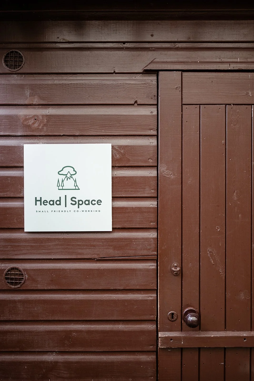 The front door of a remote co-working space with a sign that says Head | Space Nethy