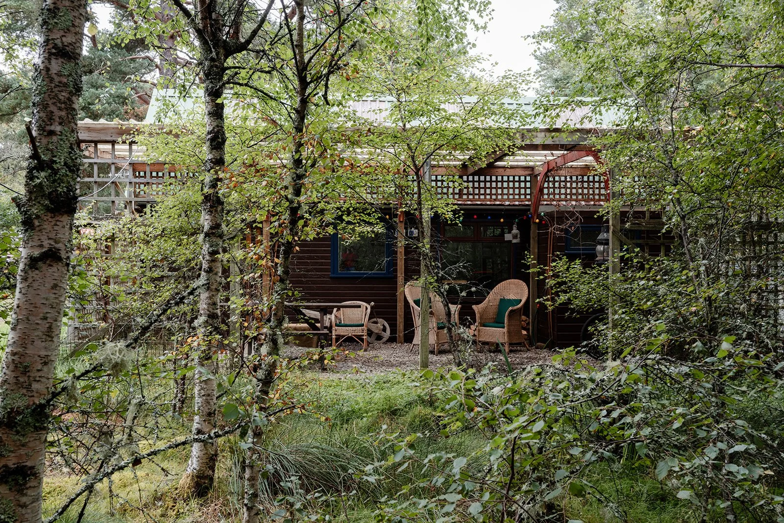 An outdoor seating area connected to a forest co-working space for remote working and workcations