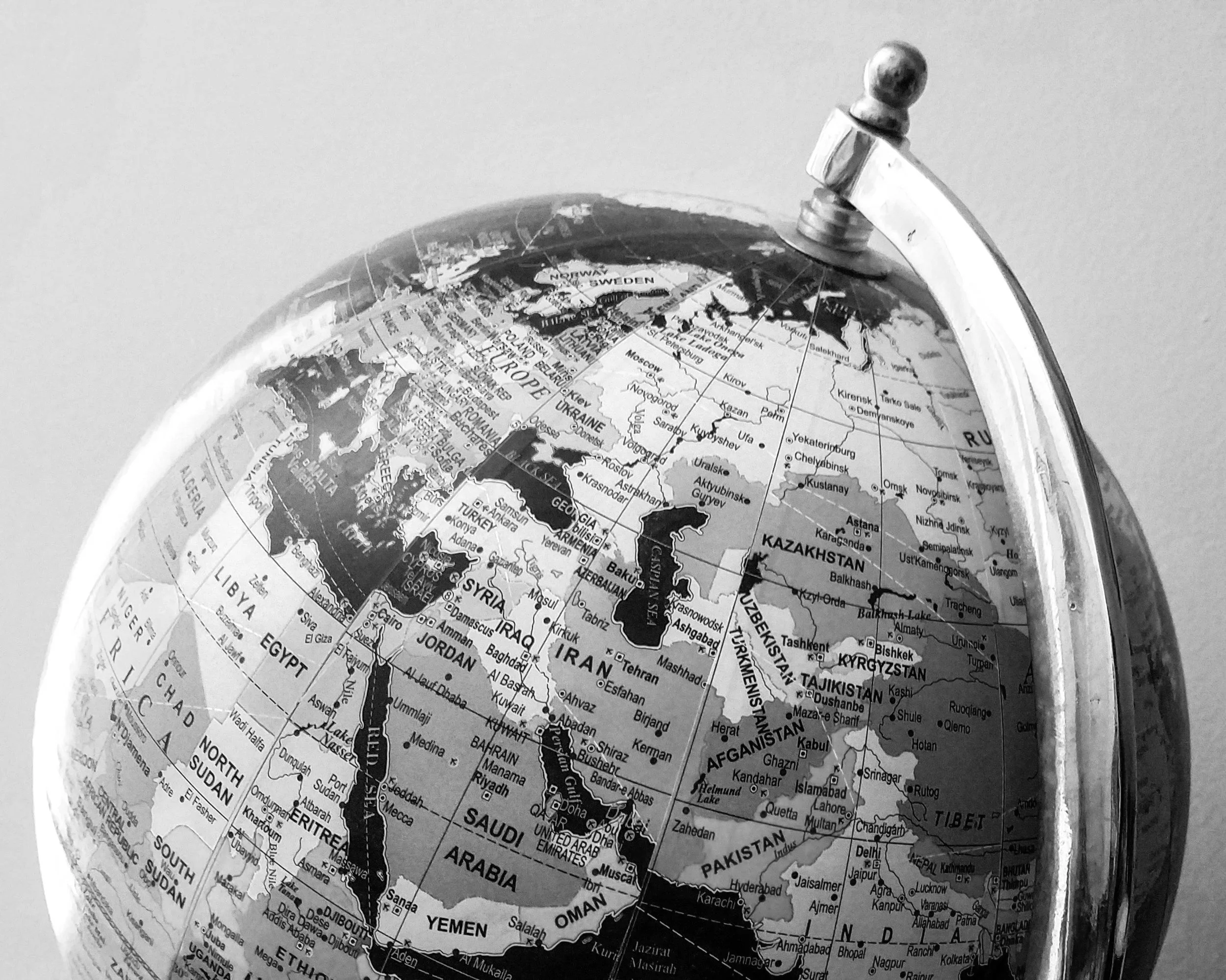 Close-up of a globe focusing on Europe, Asia, and parts of Africa showing country names and borders.