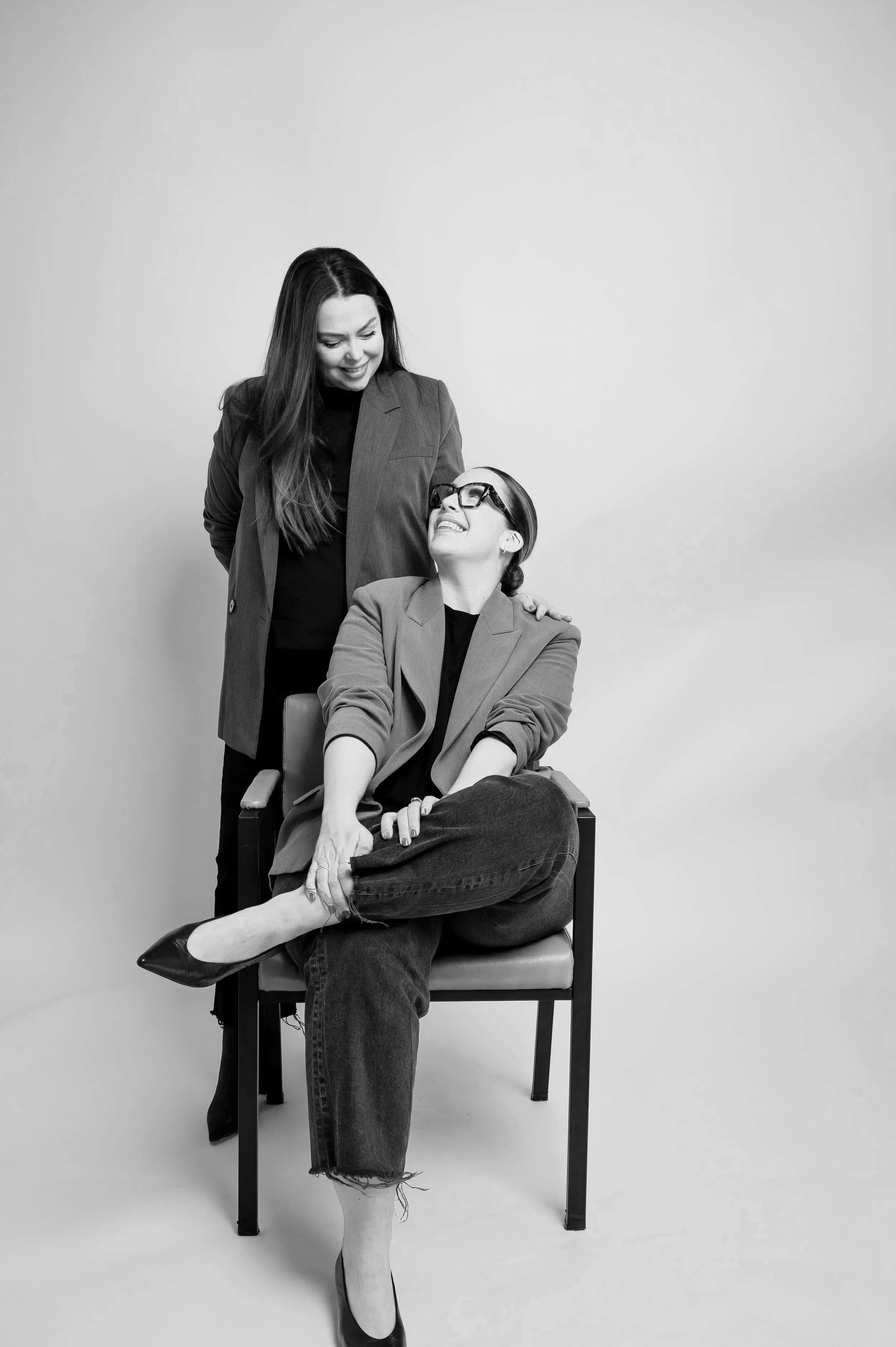 A person with glasses and a patterned shirt writing a workflow strategy on a whiteboard, which includes steps about cart abandonment, delays, and email responses.