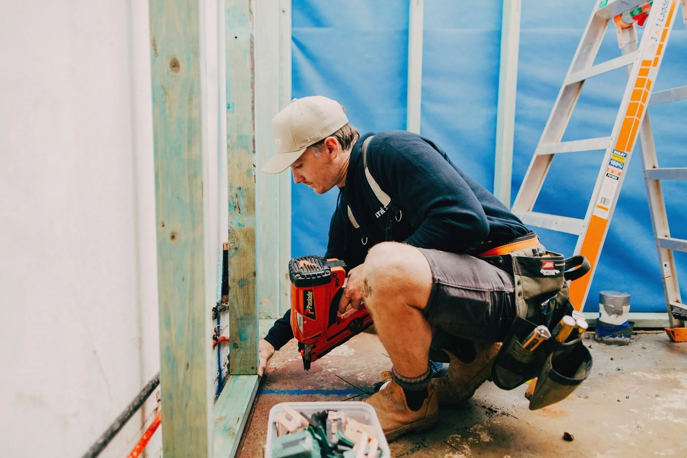 Skilled tradesman framing timber walls during construction, demonstrating the expert carpentry used in granny flats in North Shore and home extensions