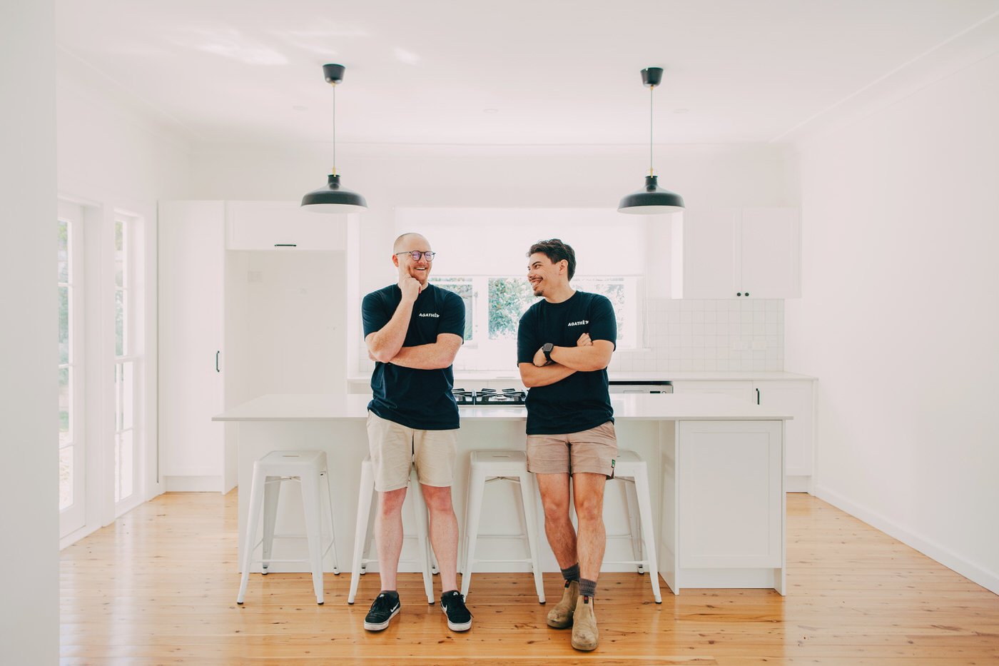 AGATHĒ building team standing in completed modern kitchen renovation, showcasing the premium finishes typical of granny flats in North Shore and extension projects