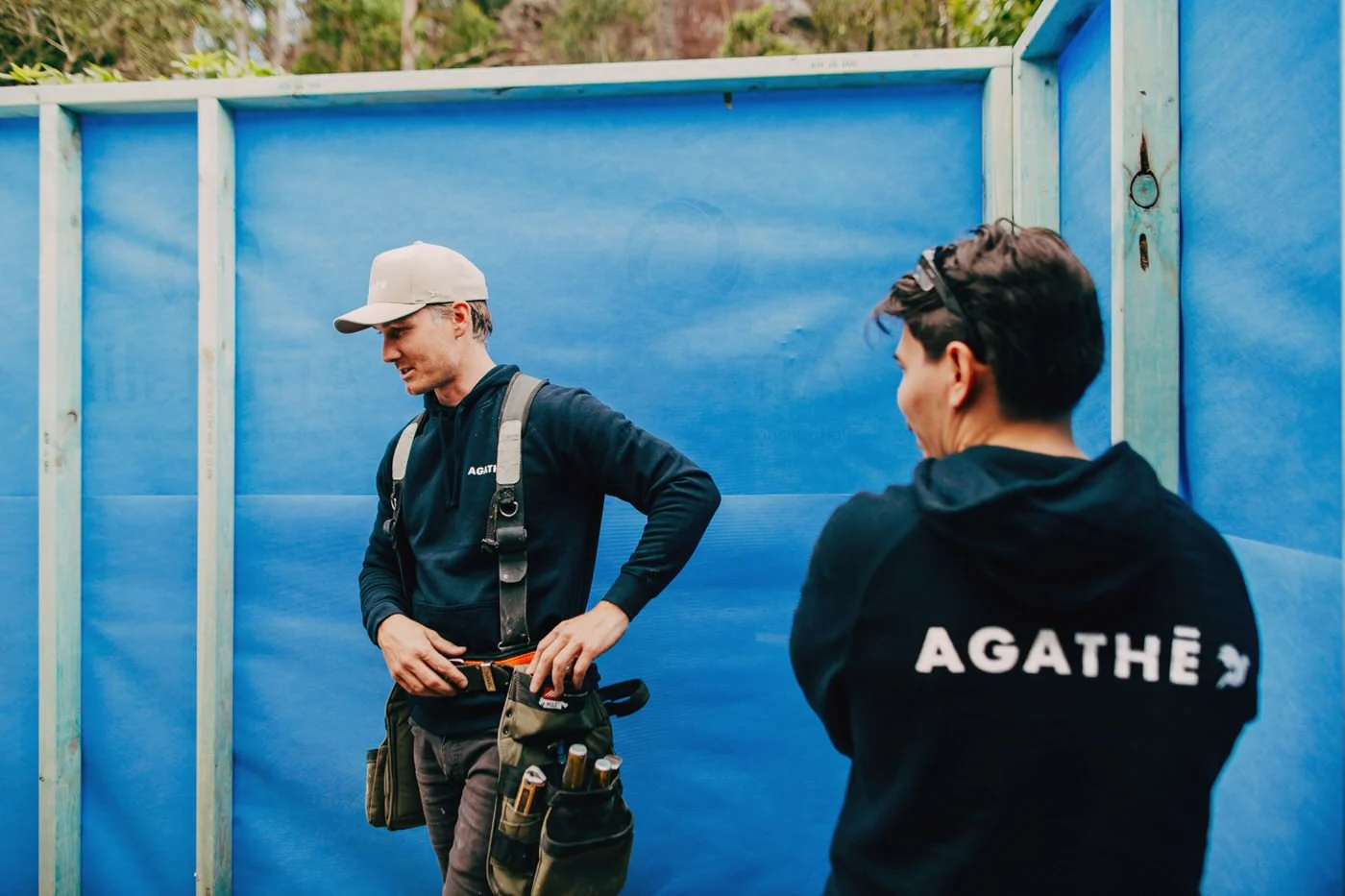 AGATHĒ building team members in branded hoodies with tool belt, specialists in custom extensions in Hills District and luxury renovation projects