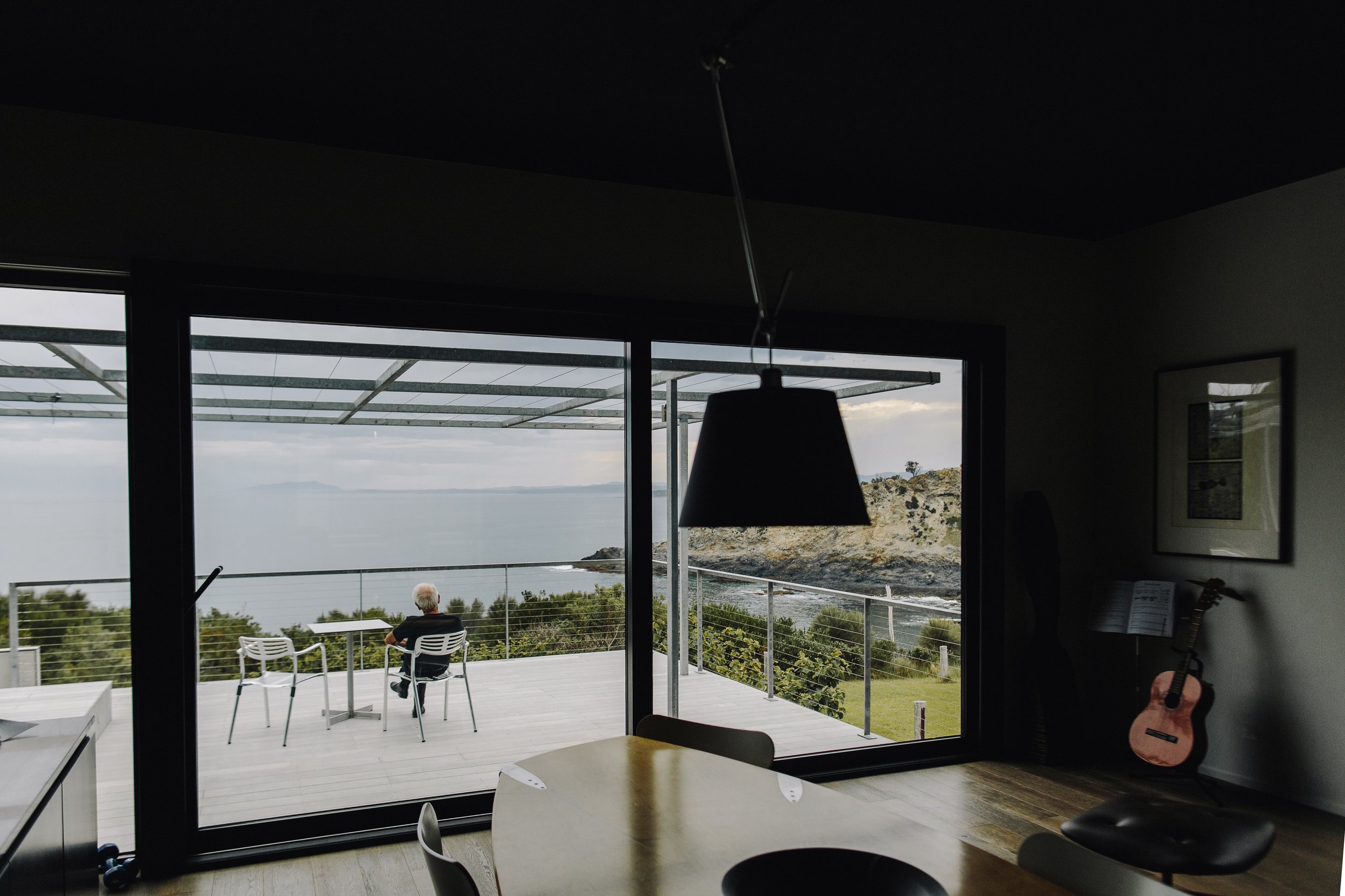 Light-filled living space with sliding glass doors opening to harbour-view balcony, showcasing the seamless indoor-outdoor flow in granny flats in Cremorne Point extensions