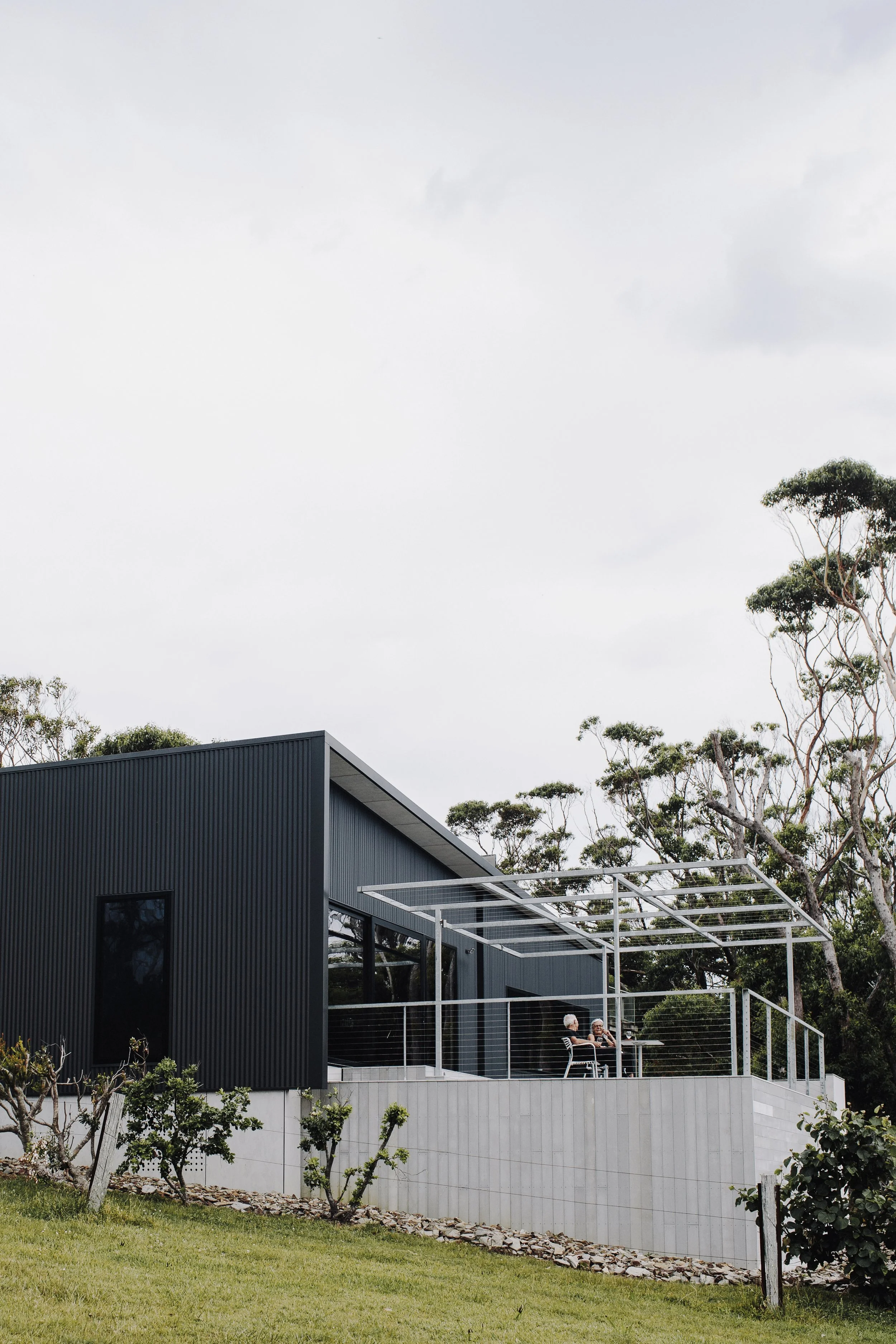 Hillside black modern granny flat in Bayview with alfresco dining area and treetop surroundings