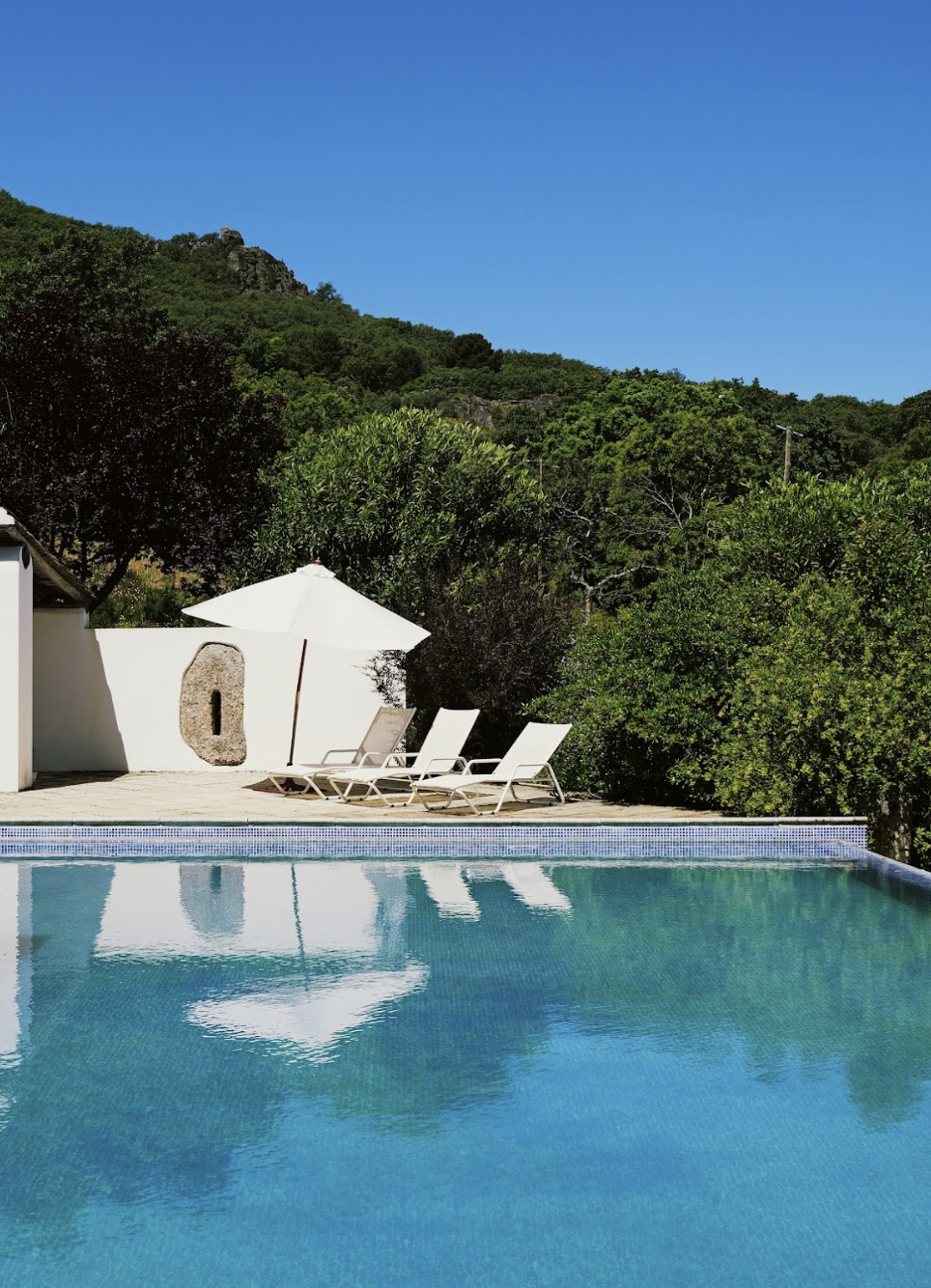 Infinity swimming pool and sun beds