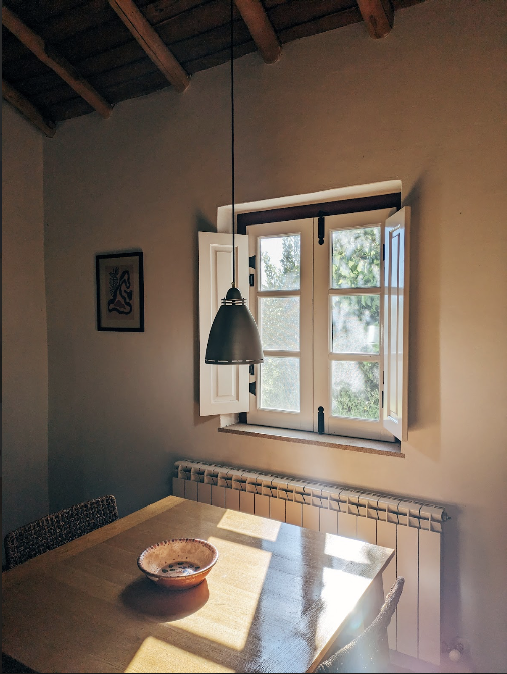 Indoor eating or work area with morning sun light entering through window