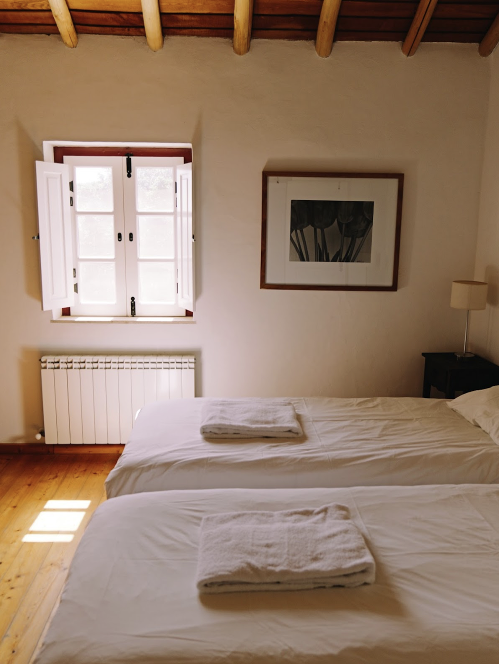 Bedroom with two single beds and extra sleeping for 1 person not shown in photo