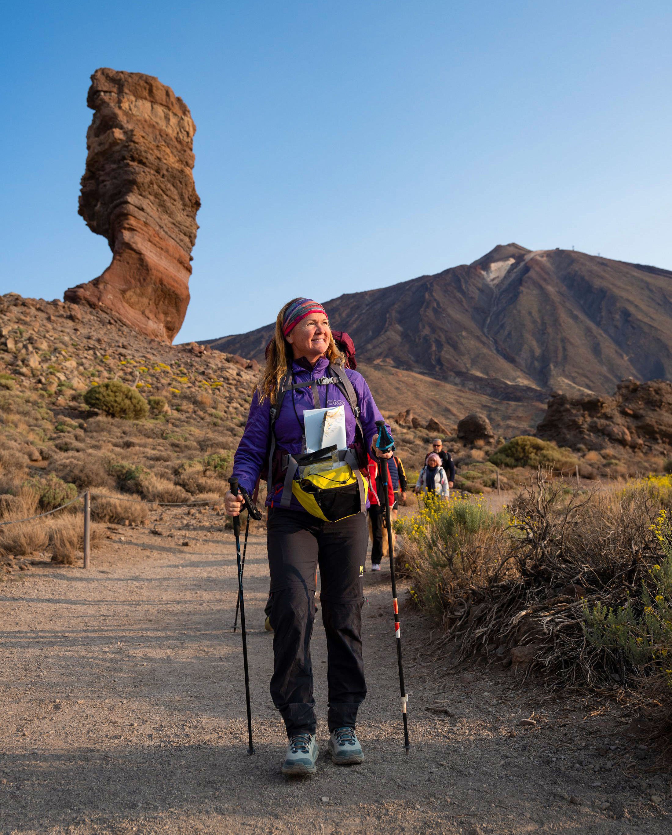Leanne Rive hiking in Tenerife, wearing outdoor gear and holding trekking poles.