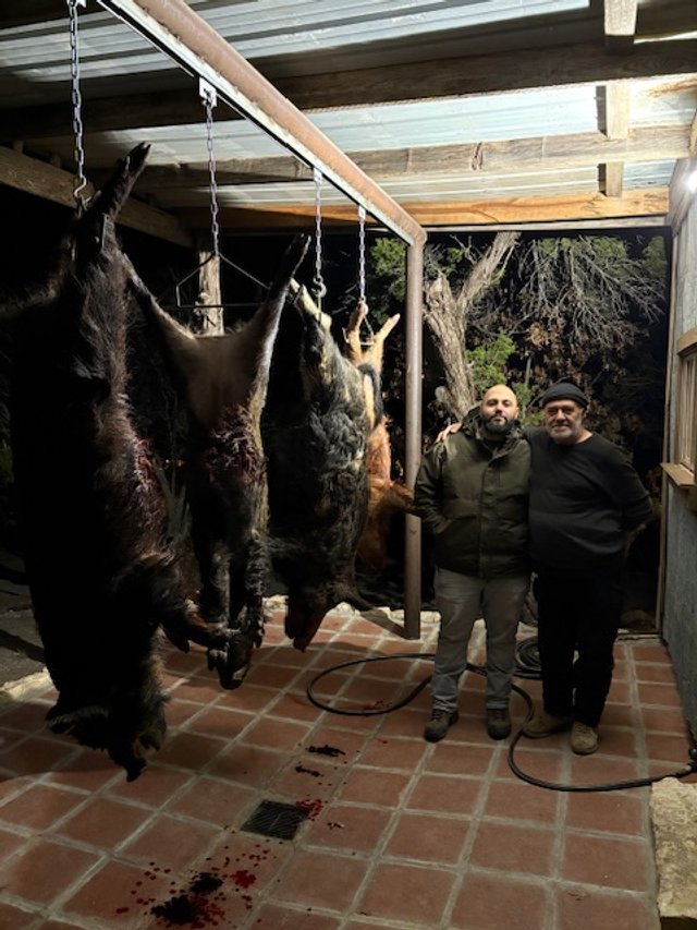 Father and son after nighttime hog hunt