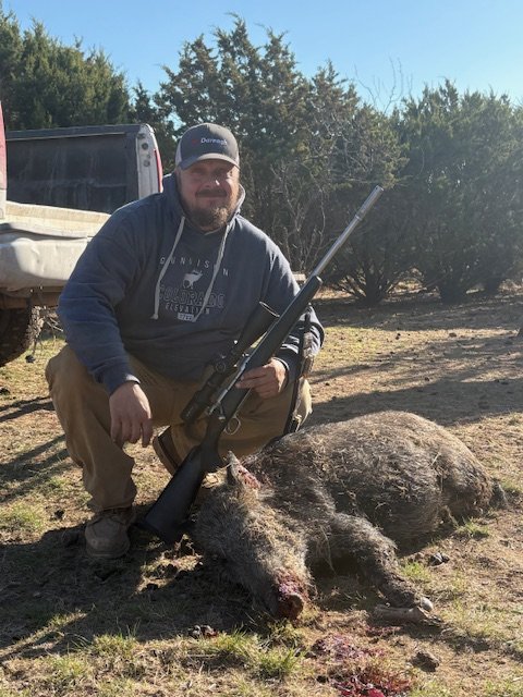 Posing in the field with wild hog