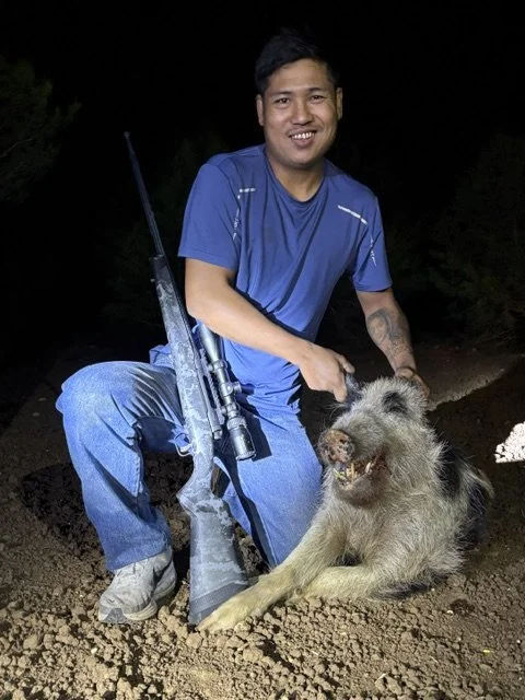 Posing in the field with wild hog