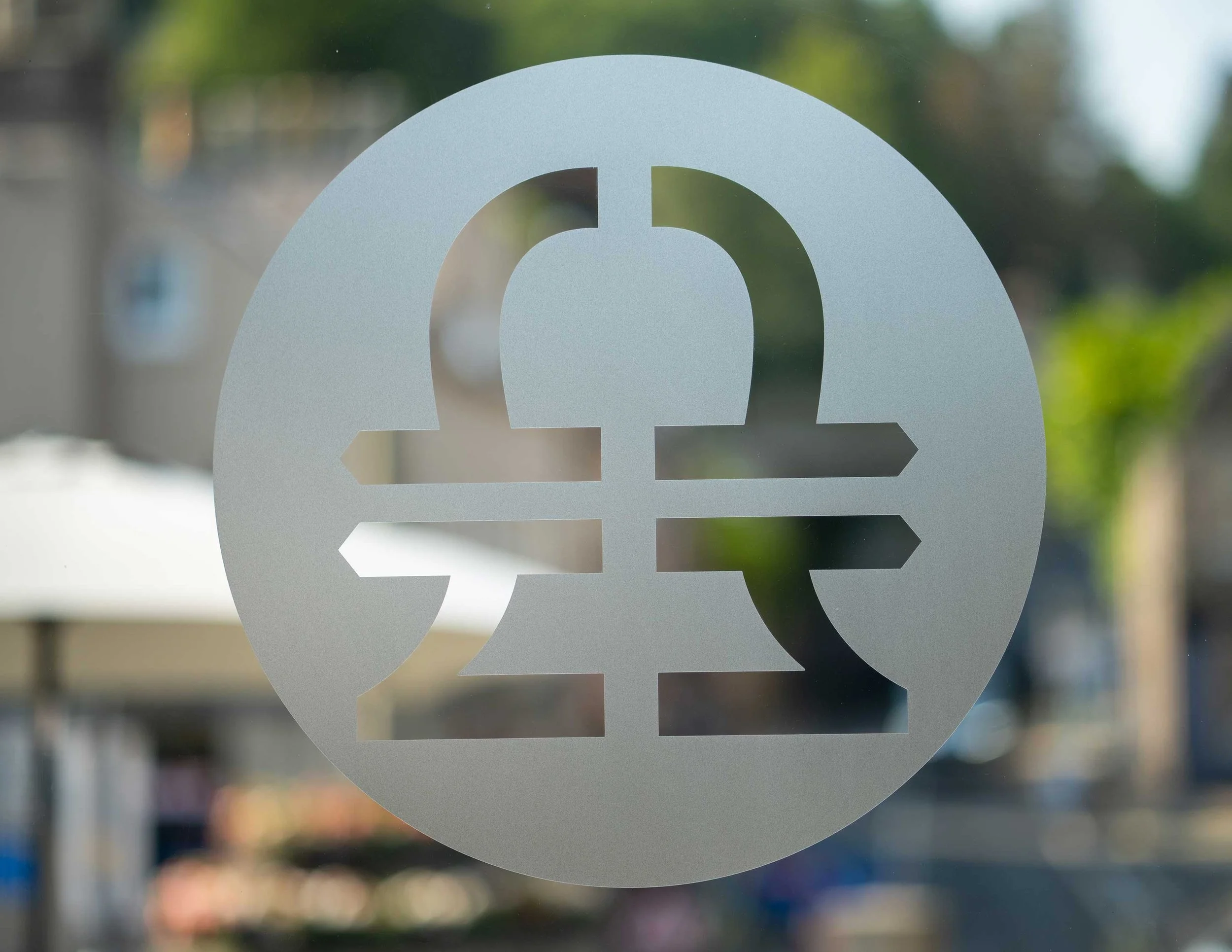 Frosted window sticker depicting Bell Financial planning logo against a blurred outdoor background.