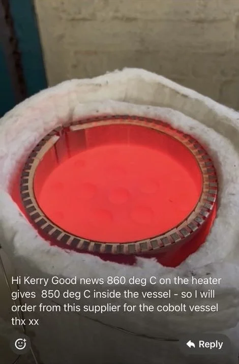 Close-up of a high-temperature industrial heater or kiln with a glowing red interior, partially covered by a white insulating material.