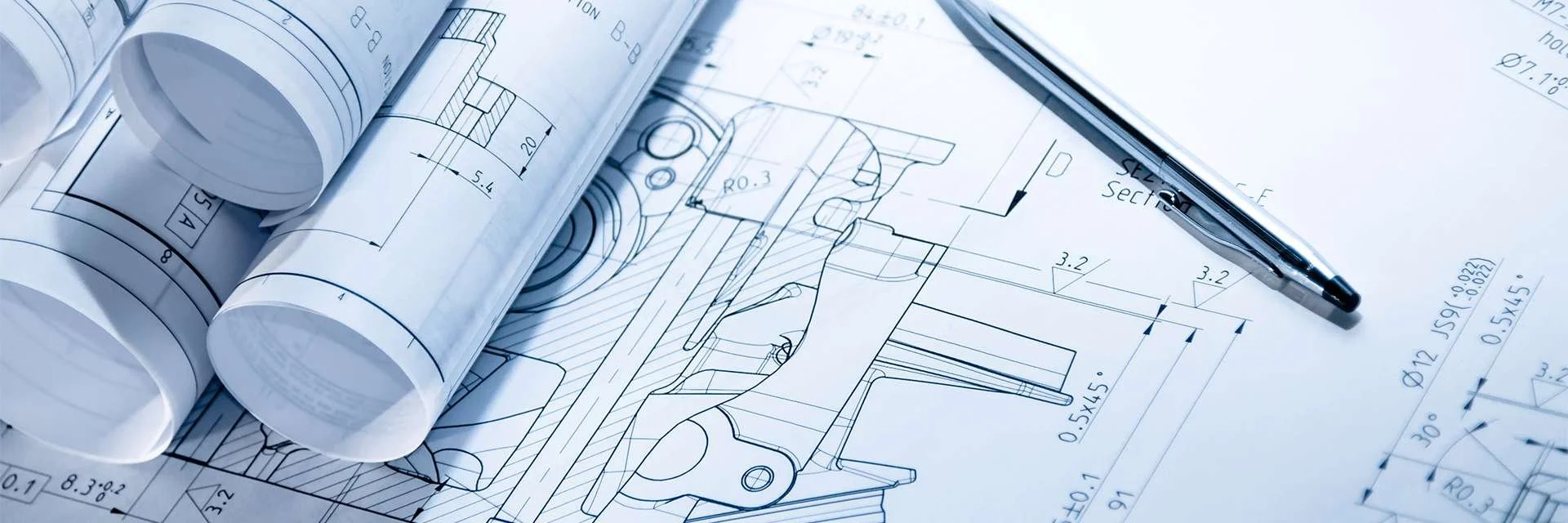 Technical engineering blueprint with detailed drawings and measurements, partially unrolled blueprints, and a black ballpoint pen.