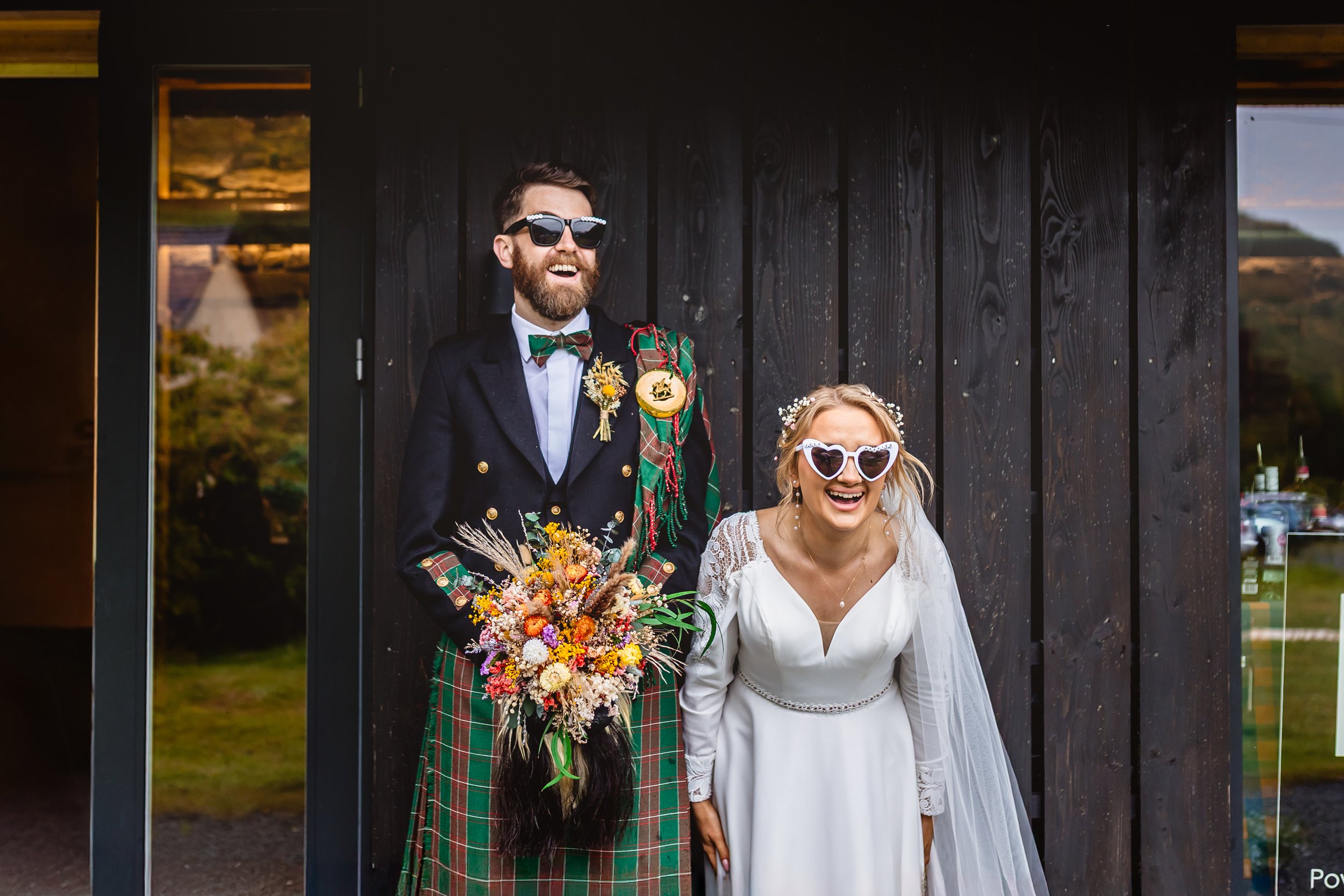 newly married couple pose candidly outside nant y walsh barn, wales