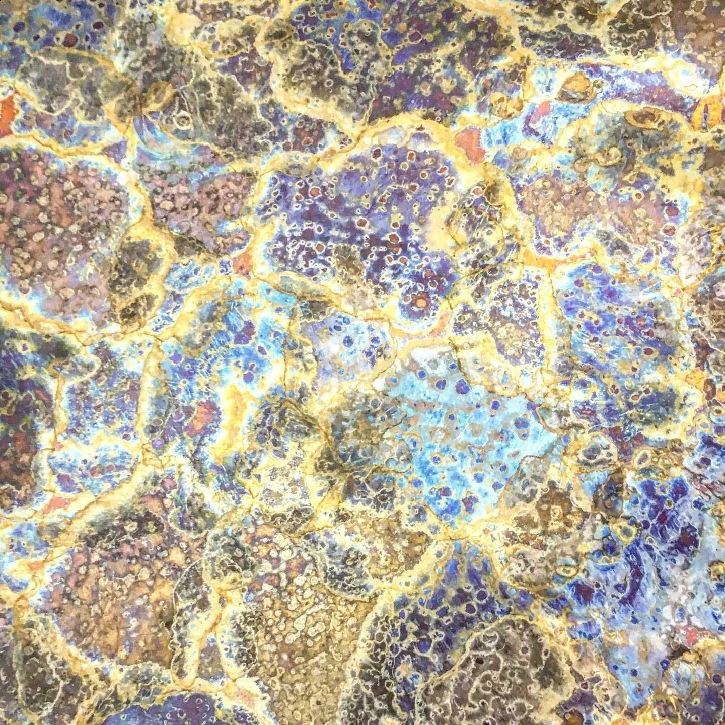 Abstract patina texture in purple, turquoise and rust tones on metal surface