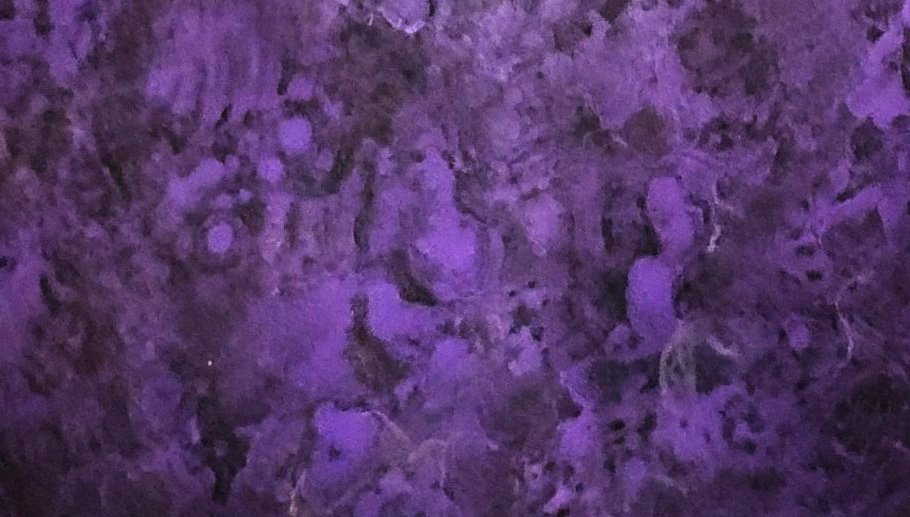Abstract patina texture in purple tones on metal surface