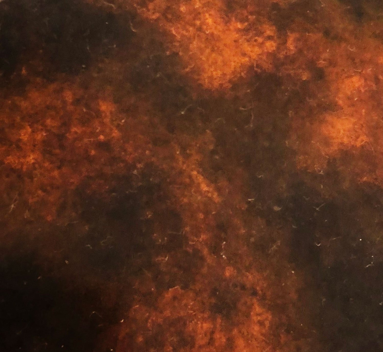 Abstract patina texture in orange and brown tones on metal surface