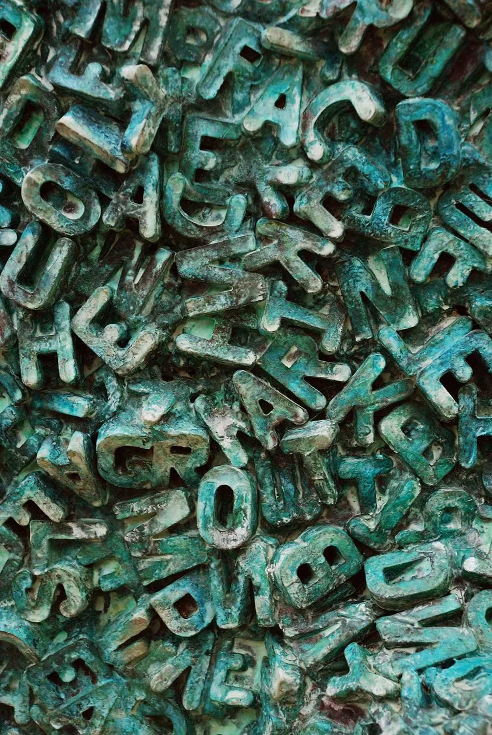 Detail of Potential, a sculpture by Michael Speller in a striking blue-green patina