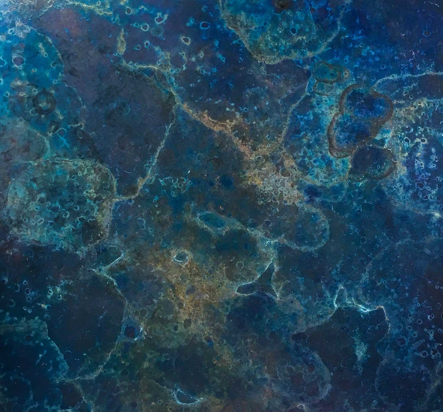 Abstract navy, azure and turquoise marble effect patina on a metal surface used in a background slideshow