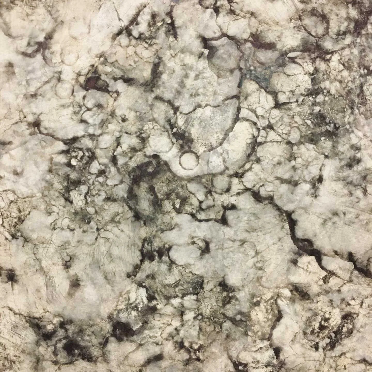Abstract pale greys and black marble like patina on a metal surface