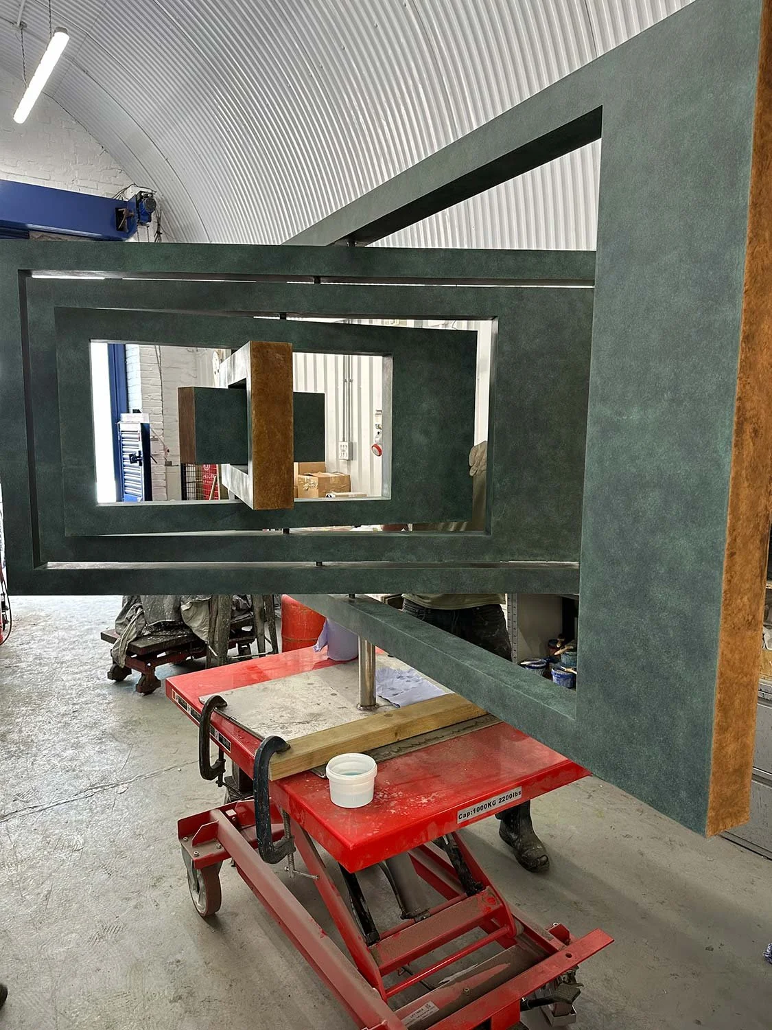 Process photo of an Ivan Black sculpture, Tabula, being patinated