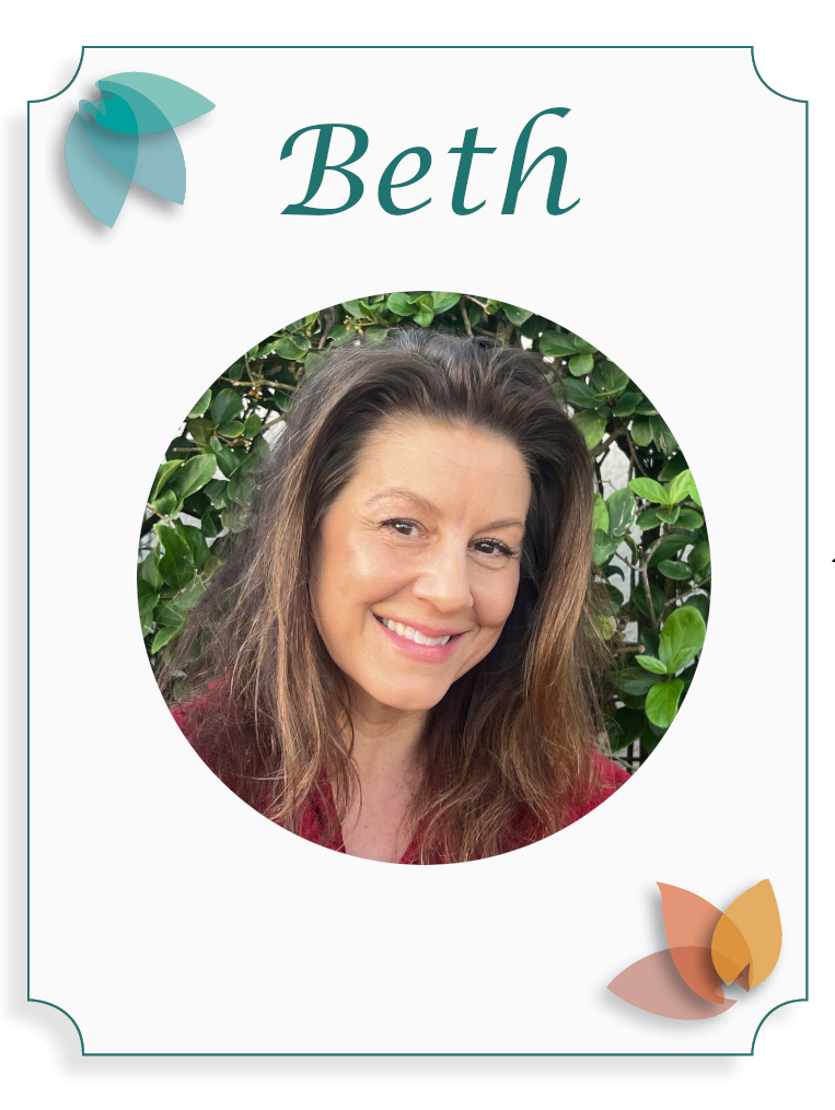 A woman named Beth smiling with brown hair, wearing a black top, standing outdoors in front of green foliage.