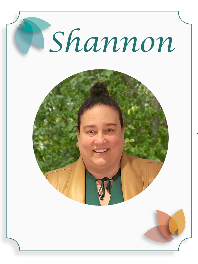 A woman with dark hair in a bun smiling outdoors with green trees in the background, on a name badge design that reads "Shannon".