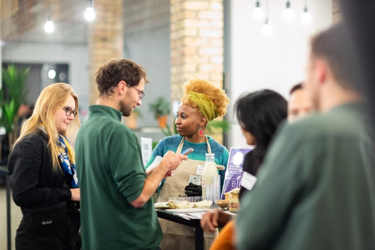 Tsarona founder Kamogelo Thumankwe presenting Bamba Bite vegan African snacks to visitors at a Berlin food and wellness event