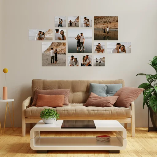 A collage of photos on a wall featuring a couple at the beach, with a beige sofa with pillows, a white coffee table, a plant, and a small table with a lamp in a modern living room.
