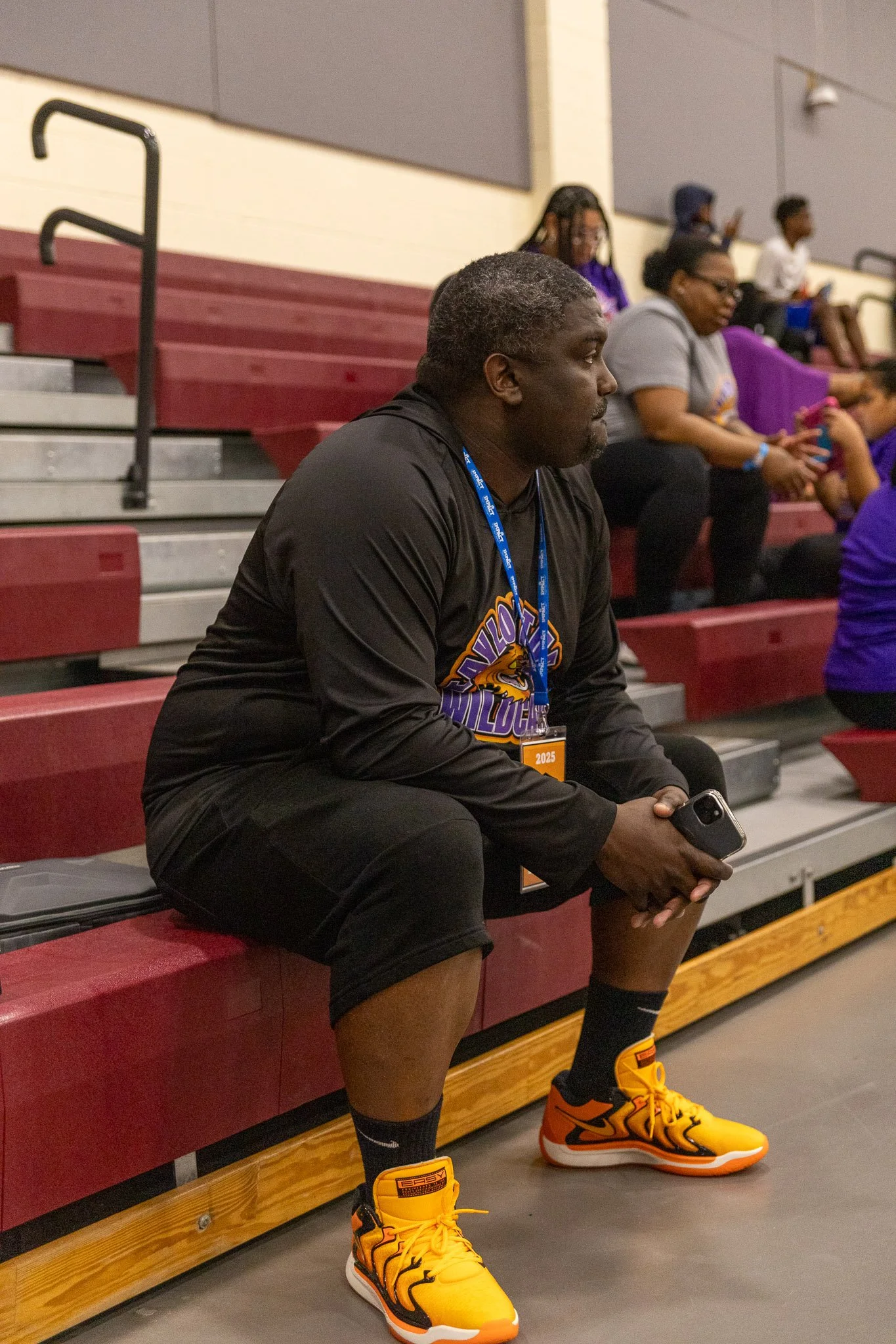 Logo for 'Tritonville Wildcats' featuring an animated snarling orange wildcat with green eyes, purple and black accents, with text in purple and orange.