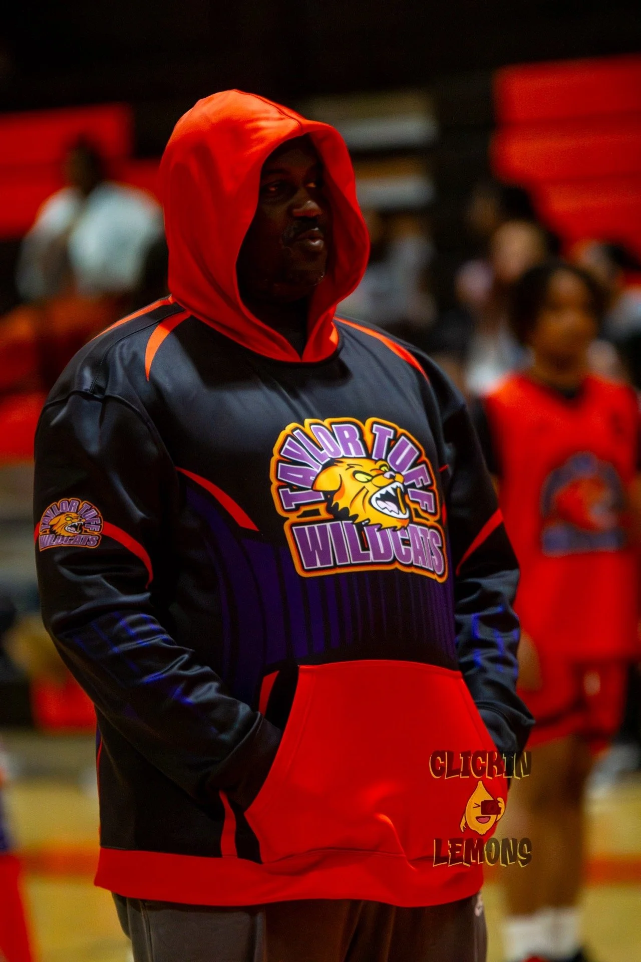 Logo for 'Tritonville Wildcats' featuring an animated snarling orange wildcat with green eyes, purple and black accents, with text in purple and orange.