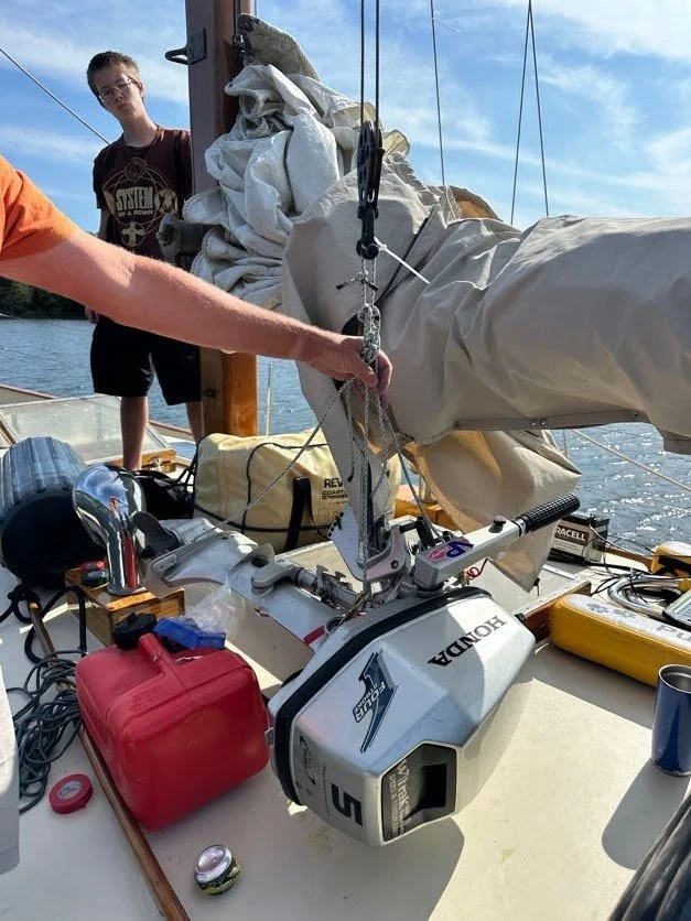Cory and Captain lifting the motor with the new bridle