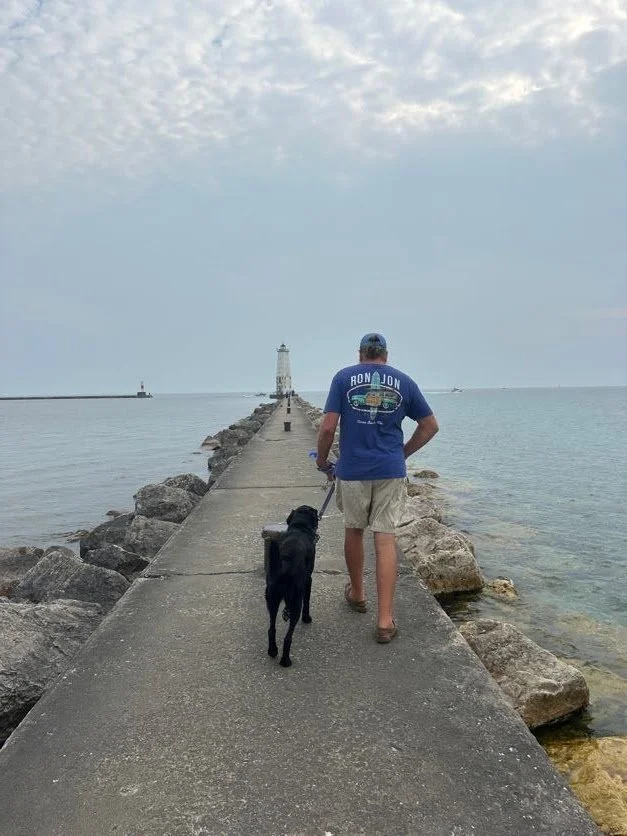 Captain and Kona walking to the lighhouse
