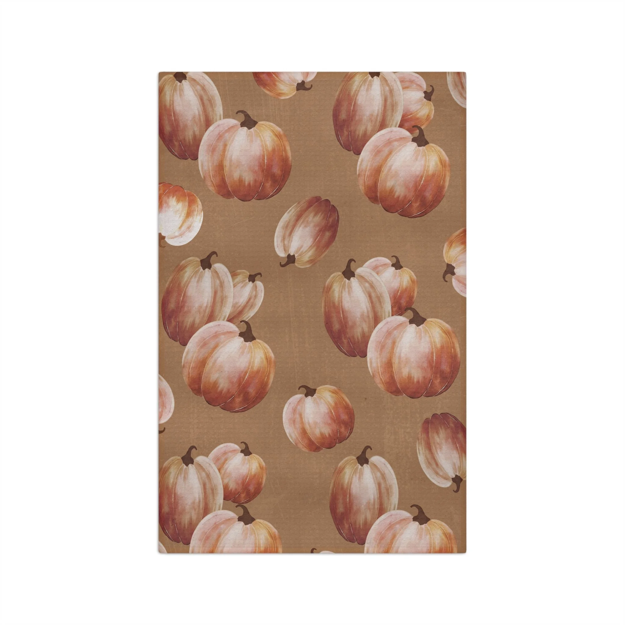 Harvest Blush microfiber waffle tea towel with watercolor pumpkins in muted blush, rust, cream, and ochre on a warm brown background.