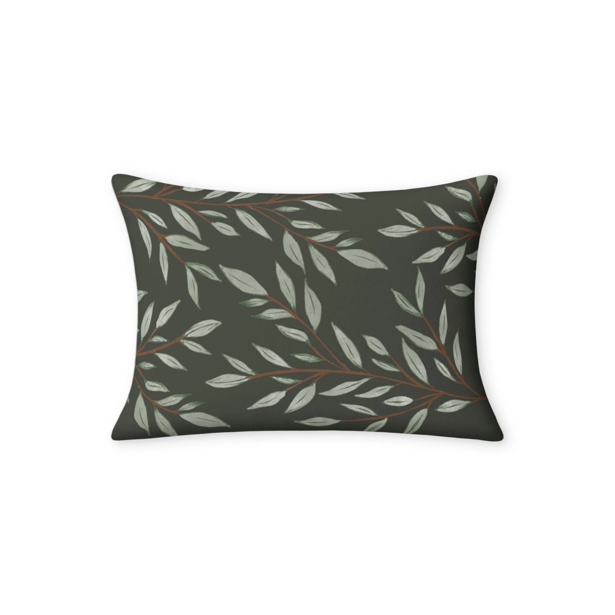 Close view of hand-painted sage leaves and warm brown branches on the dark green pillow cover.