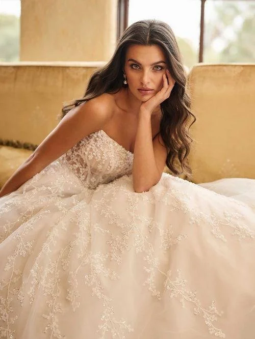 Seated bride in lace wedding gown