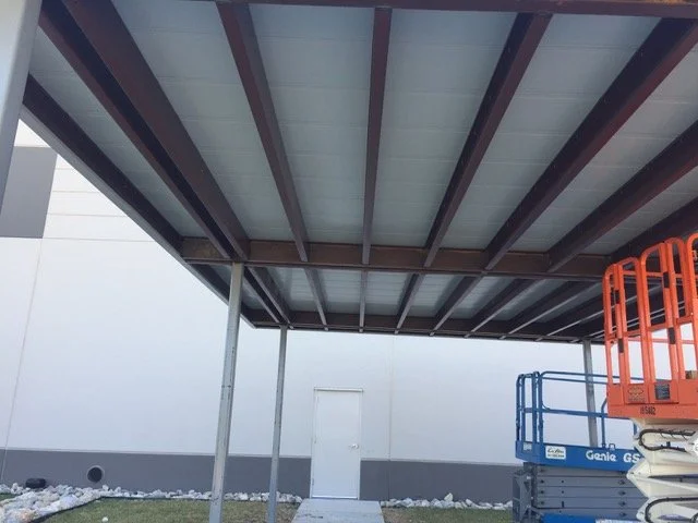 sunshade made from steel and wood in a commercial parking lot