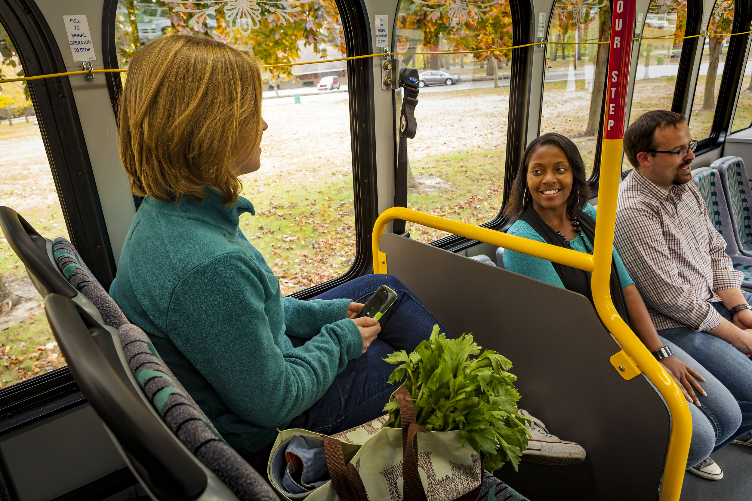 two women smiling on bus