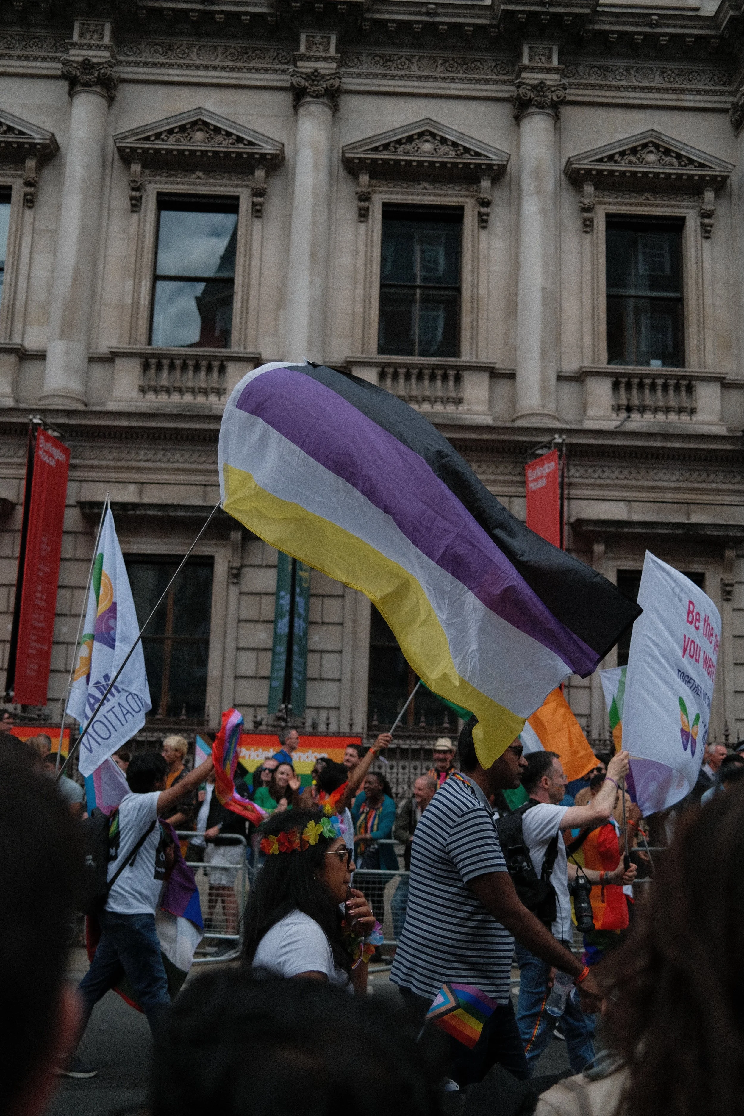 A non-binary flag held at a march or rally