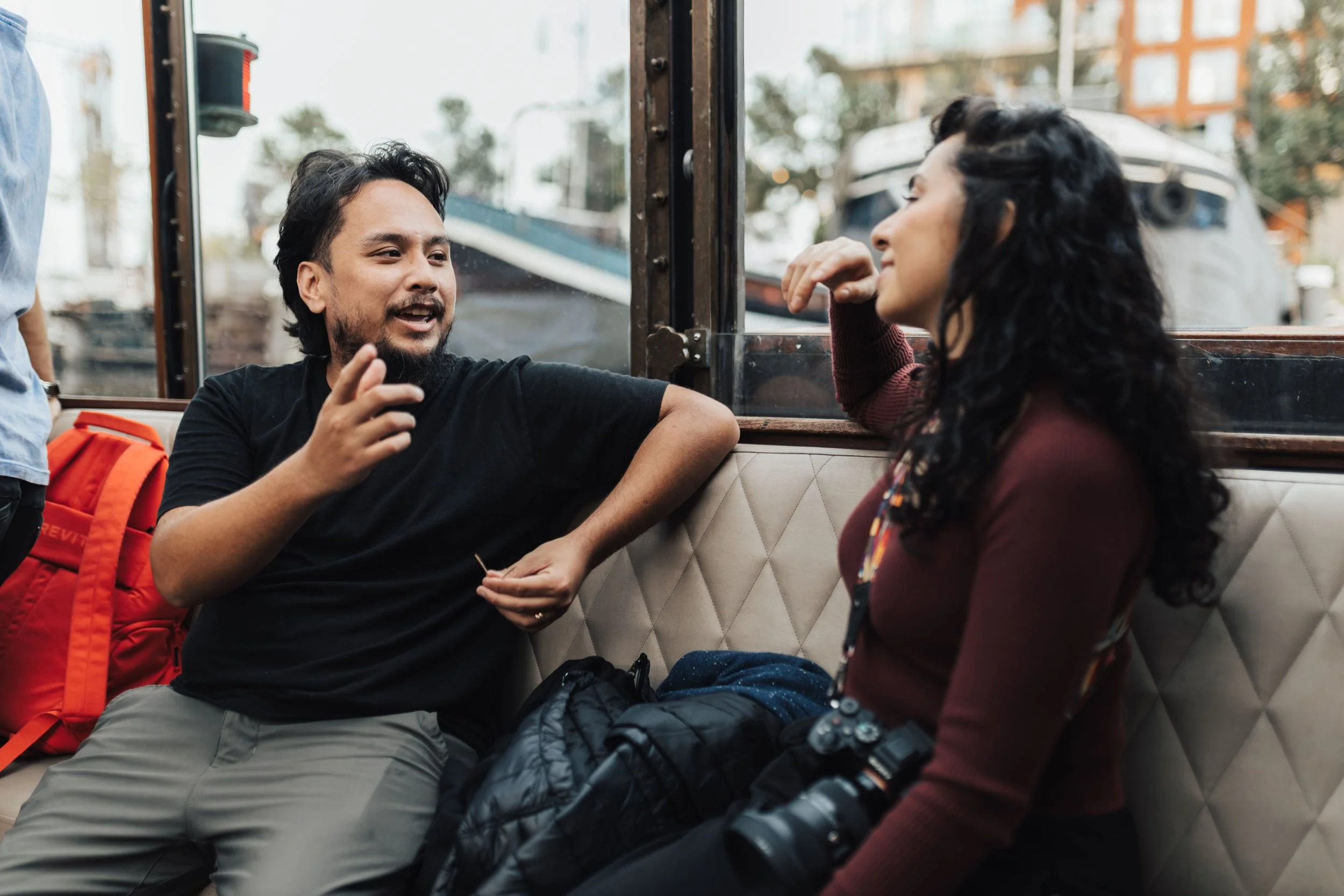 A man and a woman having a conversation indoors
