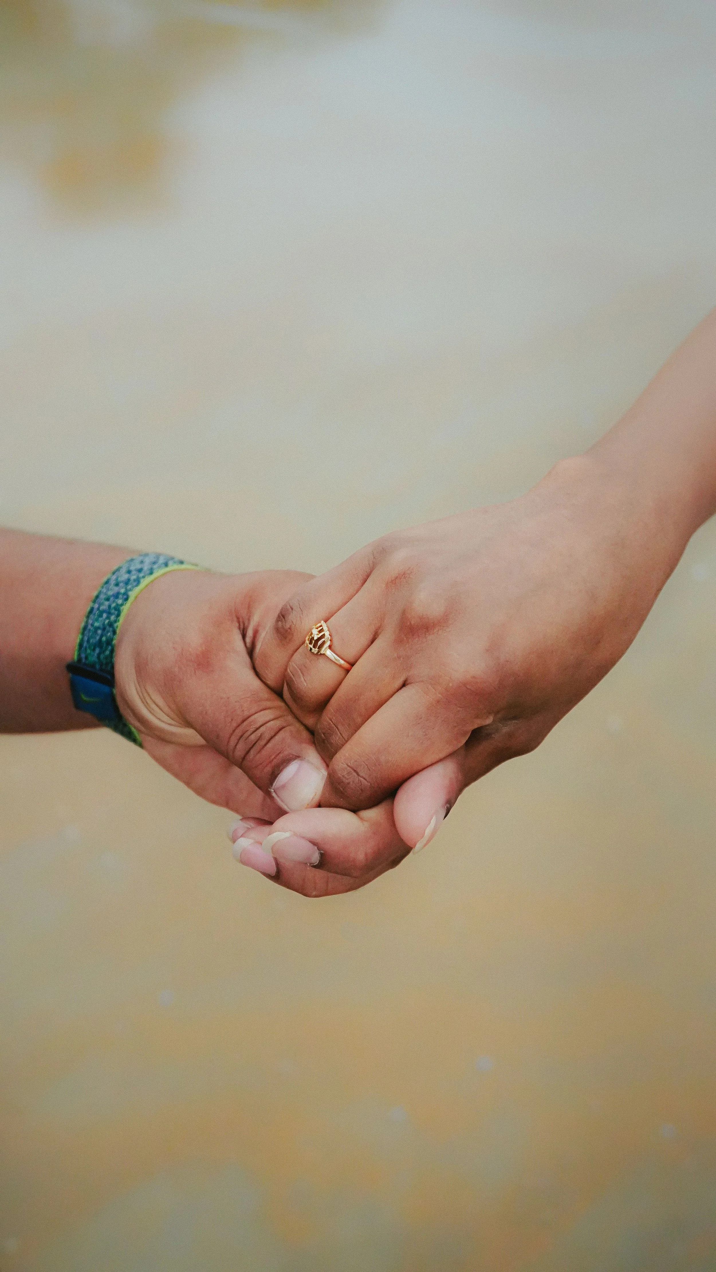 Two hands holding each other