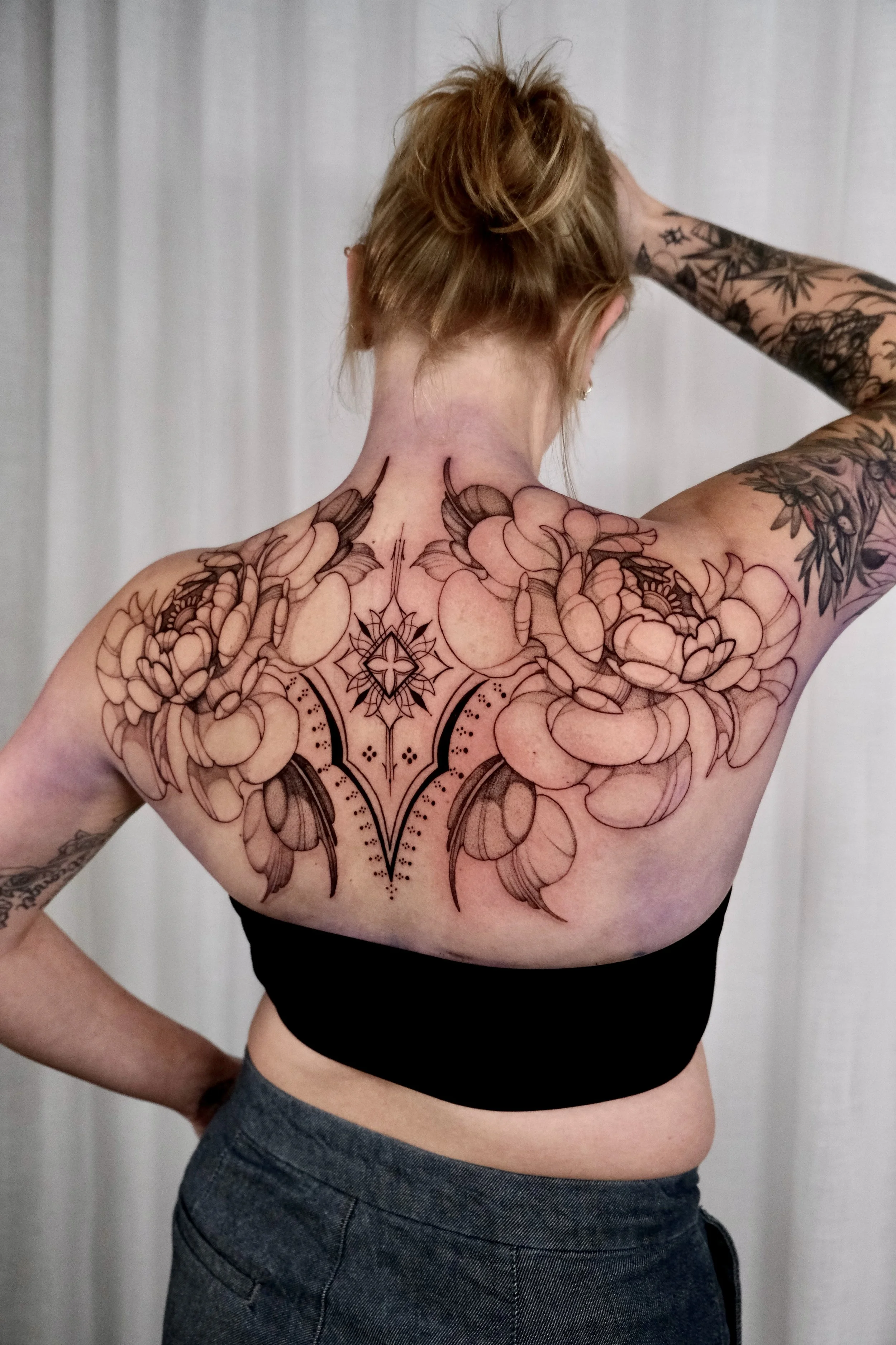 floral ornamental backpiece tattoo