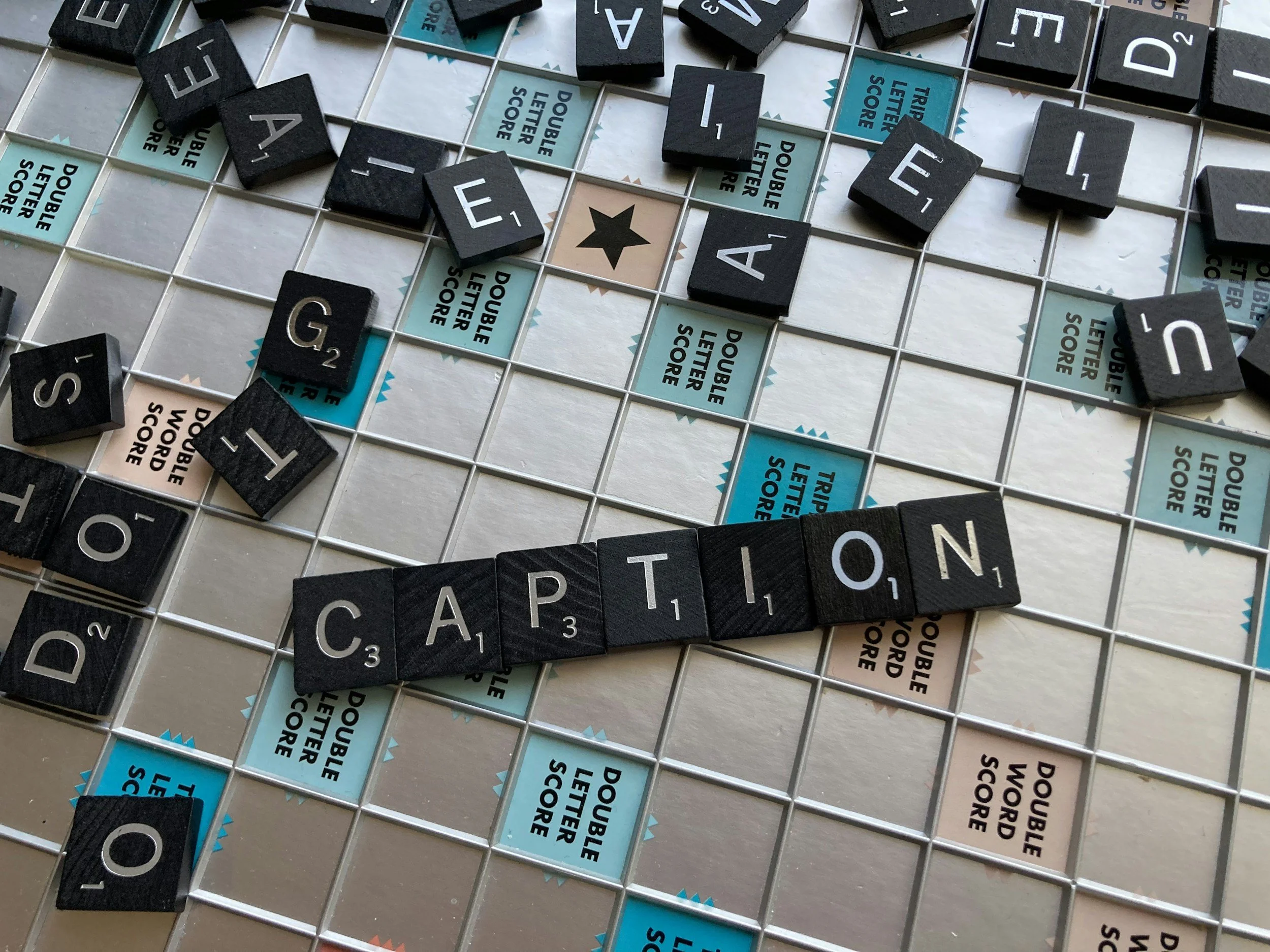 Scrabble game board with the word 'CAPTION' spelled out using letter tiles.